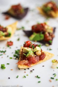 small appetizers are arranged on a plate with sprinkles and toppings