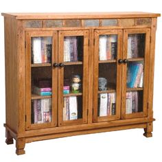 a wooden cabinet with glass doors and books on the bottom shelf in front of it