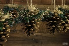 pine cones hanging from strings with flowers and greenery