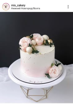 there is a white cake with pink flowers on it