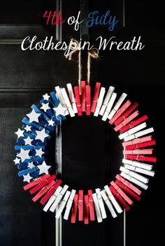 a wreath made out of red, white and blue matchesticks hanging on a door