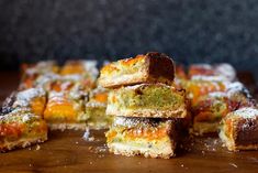 several pieces of cake sitting on top of a wooden table