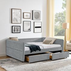 a day bed with pull out drawers in a living room