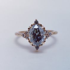 an engagement ring with a large blue diamond surrounded by smaller white and yellow diamonds on the band