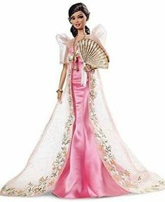 a barbie doll wearing a pink dress and holding a fan in her hand, on a white background