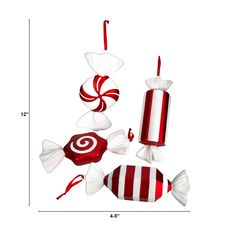 three red and white candy lollipops sitting on top of each other in front of a white background