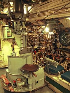 the inside of an old ship with many items on it and a clock in the background