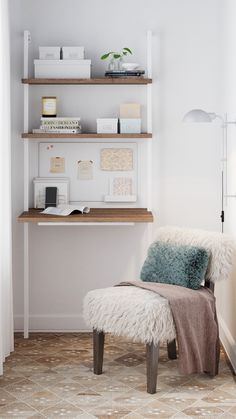 a white chair sitting in front of a desk with shelves above it and a rug on the floor