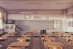 an empty classroom with desks and chairs