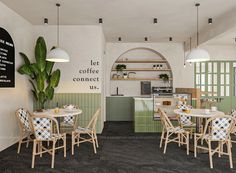 the interior of a coffee shop with tables and chairs