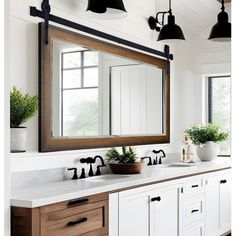 a bathroom with two sinks and a large mirror on the wall above it's counter