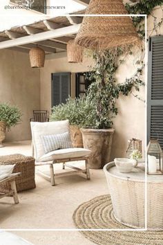 an outdoor patio with wicker furniture and potted plants