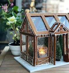 an image of a small house made out of wood with windows on the front and side