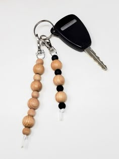 a wooden beaded keychain with a car keys fobring attached to it