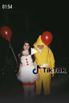 a man and woman dressed in costumes standing next to each other with red balloons attached to them