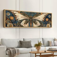 a living room with a couch, coffee table and painting on the wall above it