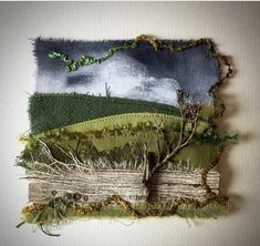 a piece of art that is made out of fabric and yarn with trees on it