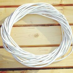 a close up of a white cord on a wooden surface