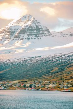 the mountains are covered with snow and houses