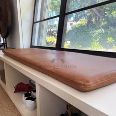 a window sill with a brown cushion on it