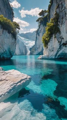 the water is crystal blue and there are mountains in the background