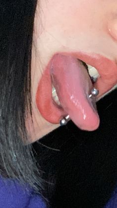 a close up of a person with a fake tongue sticking out of it's ear