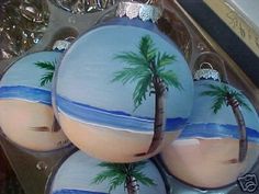 three decorated cookies with palm trees on them