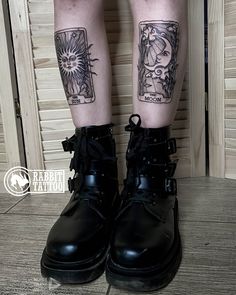 a person with tattoos on their legs wearing black boots