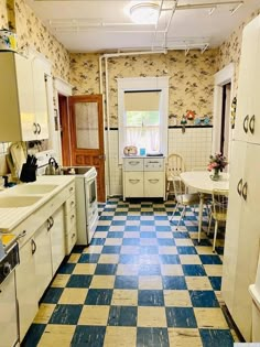 an old fashioned kitchen with blue and white checkered flooring on the tile floors