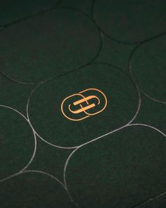 a close up view of the logo on a black surface with circles and lines around it