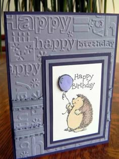 a happy birthday card with a hedge holding a balloon