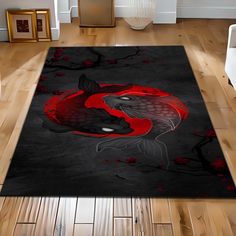 a black rug with red fish on it