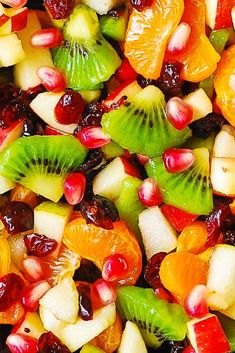 fruit salad with kiwis, oranges, apples, cranberries and pomegranates