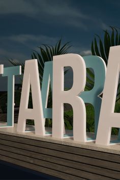 the letters are made out of wood and have white letters that spell out tarara