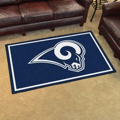 the los angeles rams rug is on the floor next to two brown leather couches