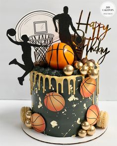 a birthday cake decorated with basketballs and gold balls