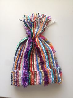 a multicolored hat hanging on the wall