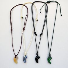 The magatama pendants are 30 mm long, 18 mm wide and 8-9 mm thick. The ropes are adjustable and made of leather (red, white), waxed cotton cord (black), Milan cord (green) The gemstones are White agate, Black agate, Sodalite, and Malachite. It is possible to choose another material and color for each pendant -- please get in touch. Luggage Case, Velvet Quilt, Carpet Bag, White Agate, Black Agate, Purple Velvet, Quilted Bag, Cotton Cord, Waxed Cotton