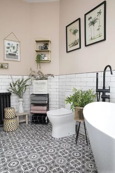 a bathroom with black and white tile flooring next to a bathtub, toilet and sink