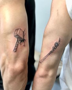 two people with tattoos on their arms holding knives