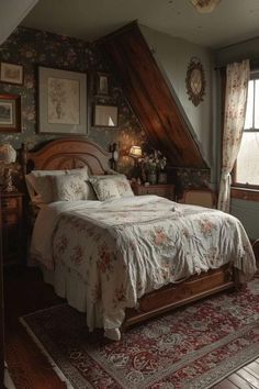 a bed sitting under a window in a bedroom next to a rug on top of a wooden floor