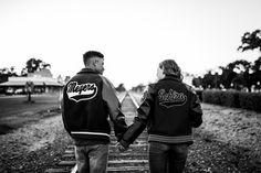 black and white photograph of two people holding hands