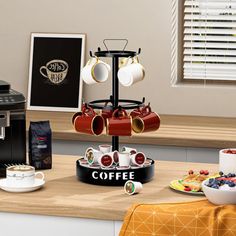 there is a coffee maker and cups on the counter in front of the coffee machine