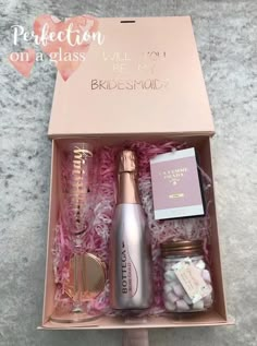 the bridesmaid gift box is open to reveal its contents and it's inside