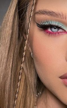 a woman with long blonde hair and blue eyeshadow is wearing pink eyeliners