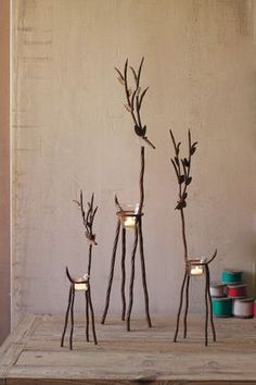 three candles are arranged in the shape of branches