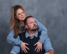 a man sitting on top of a woman's shoulders