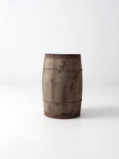 a wooden barrel sitting on top of a white table