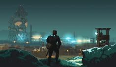 a man standing on top of a snow covered hillside next to an industrial area at night