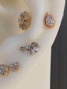 three different types of ear piercings sitting on top of each other